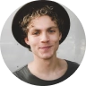 curly hair male in hat